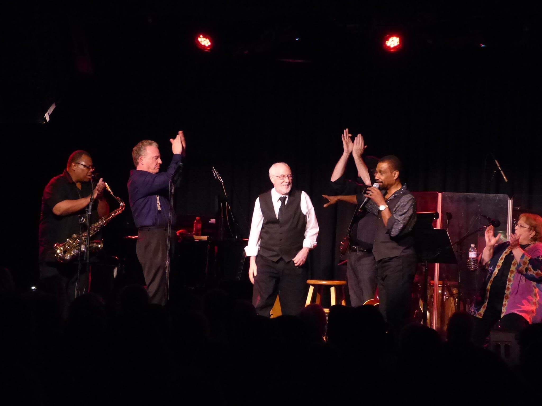 Arthur Lisi at the Birchmere with Cleve Francis musicians onstage clapping